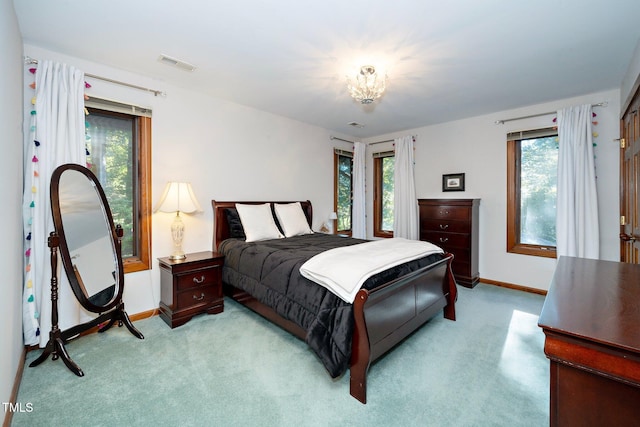 carpeted bedroom featuring multiple windows