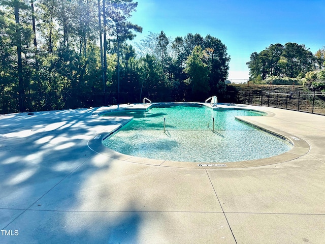 view of swimming pool featuring a patio area