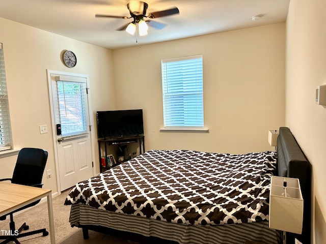 carpeted bedroom with multiple windows and ceiling fan