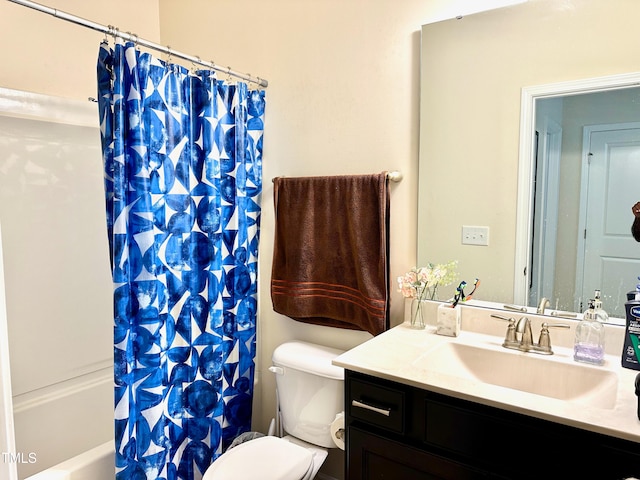 full bathroom with vanity, shower / bath combo, and toilet