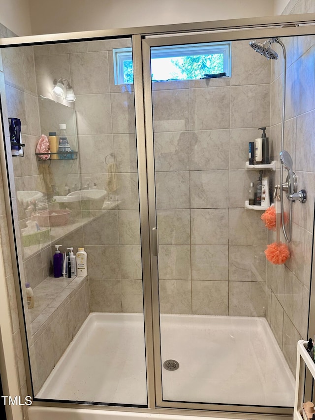 bathroom featuring a shower with door