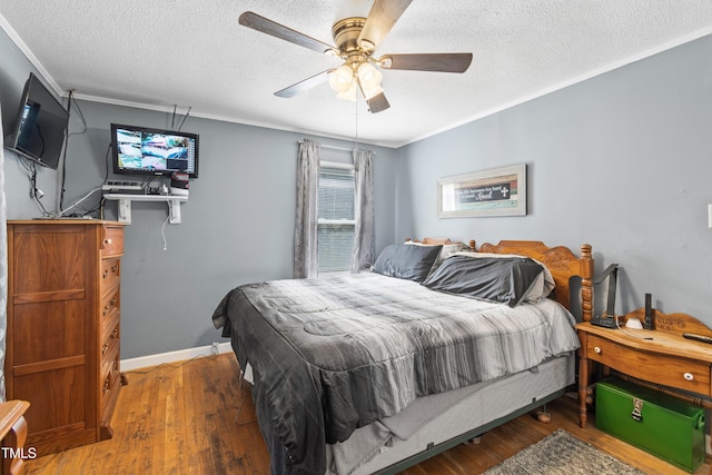 bedroom with dark hardwood / wood-style flooring, ornamental molding, a textured ceiling, and ceiling fan