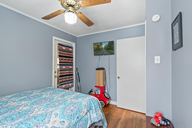 bedroom featuring ceiling fan, hardwood / wood-style flooring, and ornamental molding