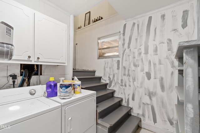 laundry room with washer and dryer and cabinets