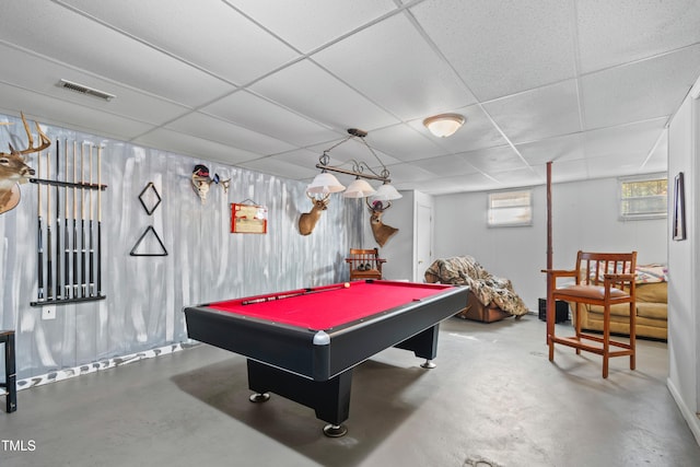 game room with pool table, a drop ceiling, and concrete flooring