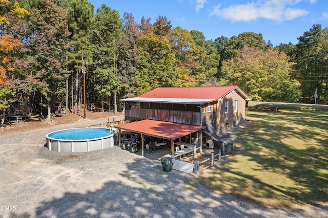 view of pool with a lawn