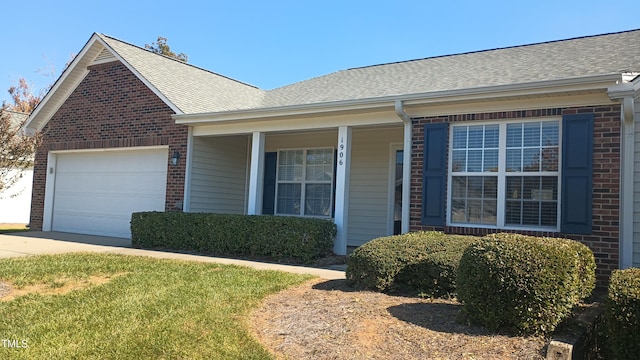 single story home with a garage and a front lawn