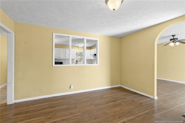 unfurnished room featuring a textured ceiling and wood-type flooring