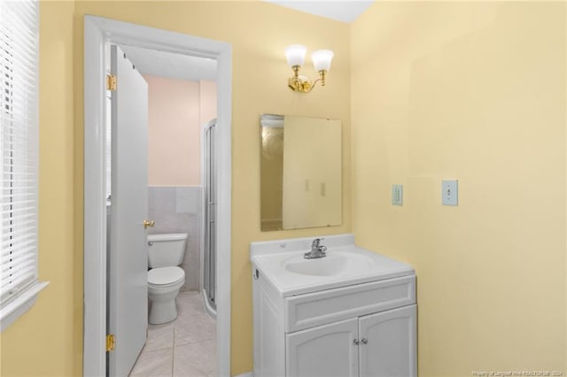 bathroom featuring vanity, toilet, and tile patterned flooring