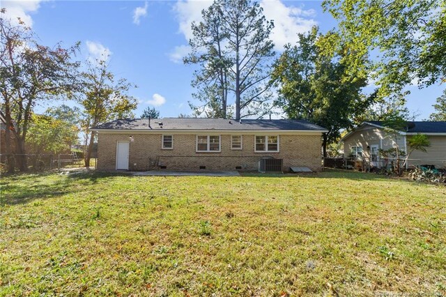 rear view of property with a yard