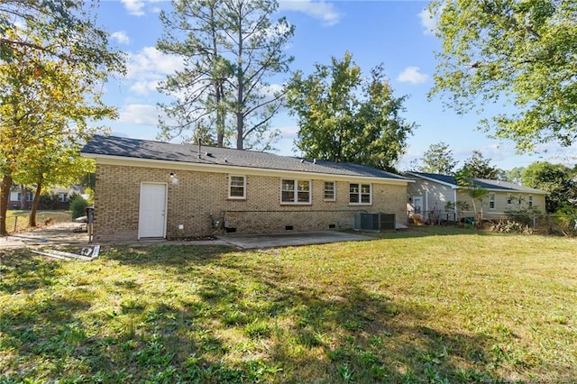 rear view of property featuring a yard, central air condition unit, and a patio