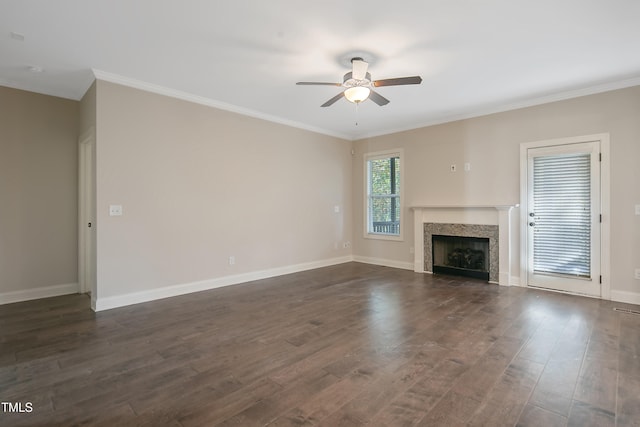 unfurnished living room featuring ornamental molding, ceiling fan, and dark hardwood / wood-style flooring