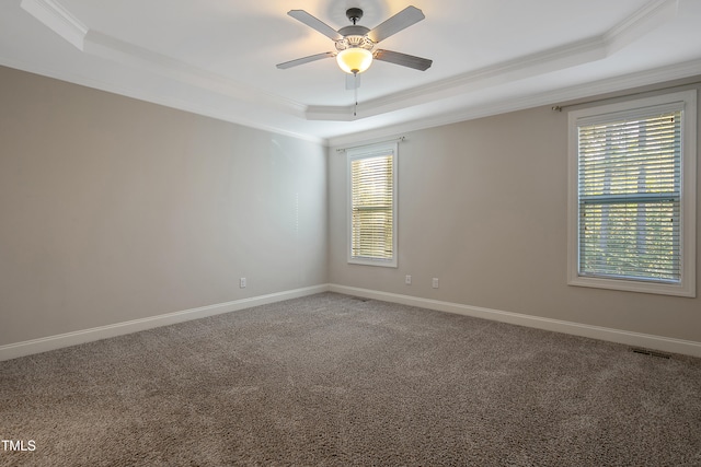 unfurnished room featuring crown molding, ceiling fan, a tray ceiling, and carpet flooring