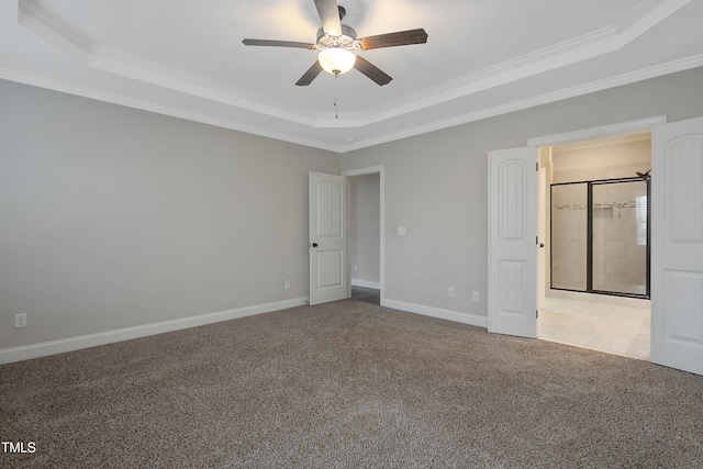 unfurnished bedroom featuring crown molding, light carpet, a tray ceiling, and ceiling fan