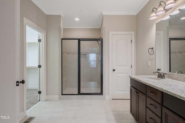 bathroom featuring vanity, tile patterned flooring, ornamental molding, and walk in shower