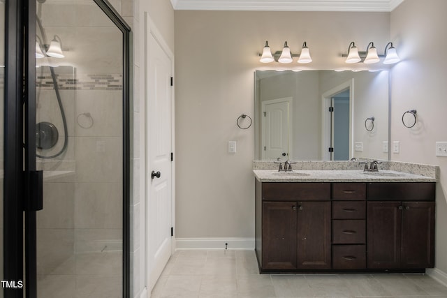 bathroom with vanity, ornamental molding, tiled shower, and tile patterned flooring