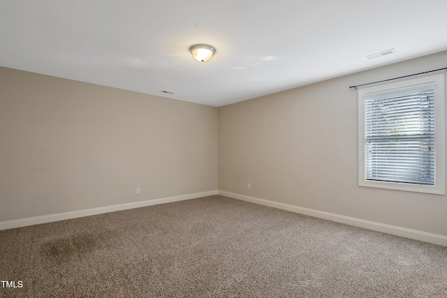 unfurnished room featuring carpet