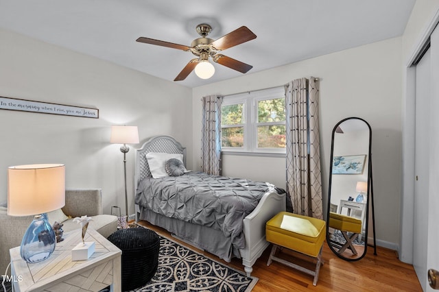 bedroom featuring a closet, wood-type flooring, and ceiling fan