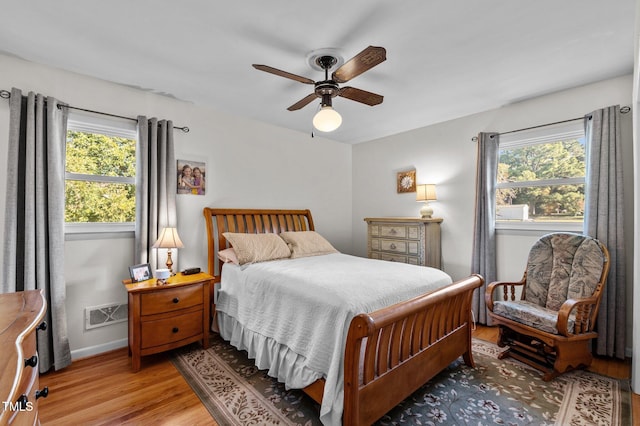 bedroom with light wood-type flooring and ceiling fan