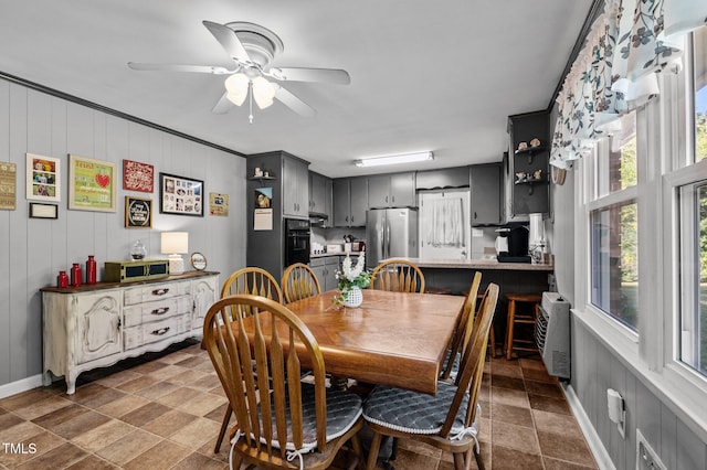 dining area with ornamental molding, heating unit, and ceiling fan