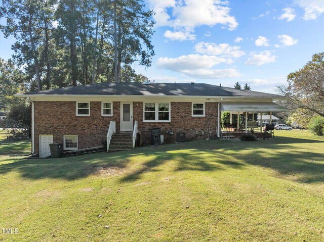 rear view of house with a lawn