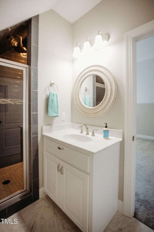 bathroom with vanity and a shower