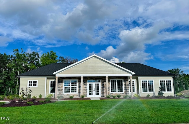 view of front facade featuring a front yard and french doors