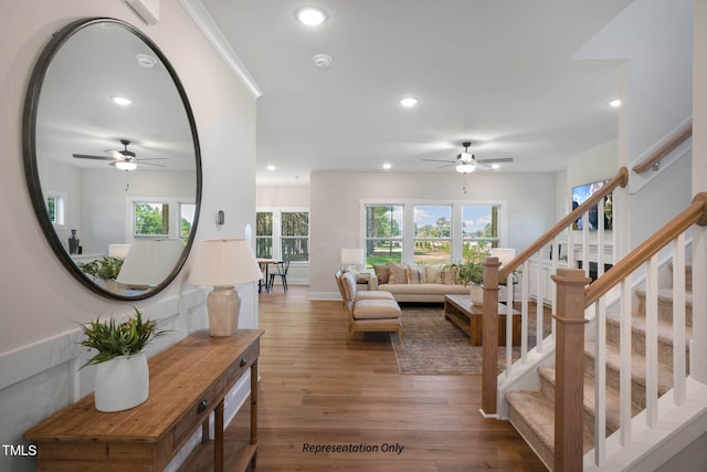 living room featuring ceiling fan and hardwood / wood-style flooring