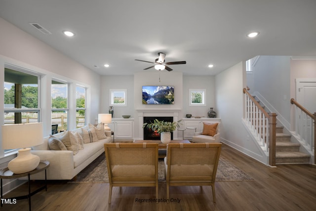 living room with dark wood-type flooring and ceiling fan