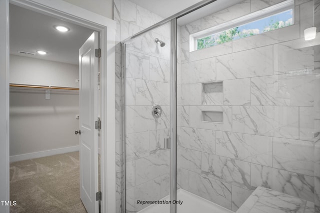 bathroom featuring a shower with door