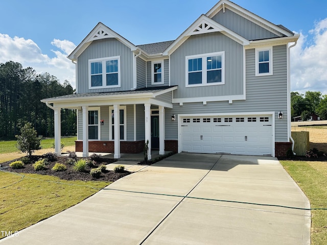 view of front of home with a porch, an attached garage, driveway, and board and batten siding