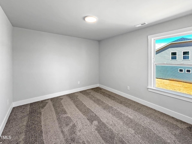 unfurnished room featuring baseboards and carpet floors