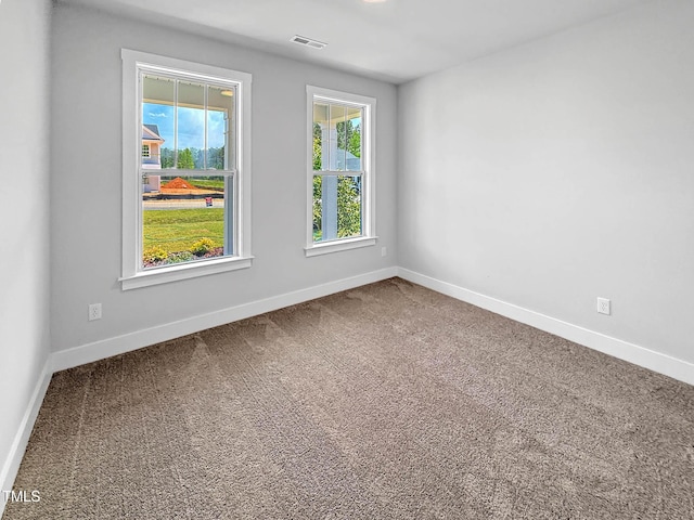 spare room with carpet and baseboards