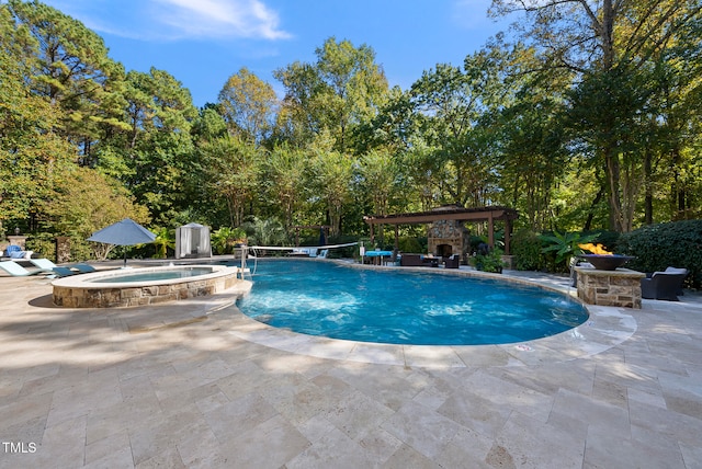 view of pool featuring an in ground hot tub, an outdoor stone fireplace, pool water feature, and a patio area