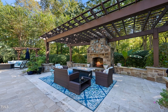 view of patio / terrace with an outdoor living space with a fireplace and a pergola