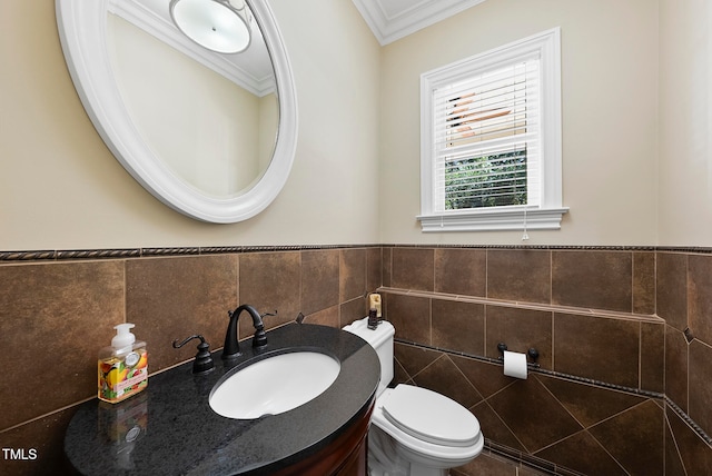 bathroom featuring vanity, toilet, tile walls, and ornamental molding