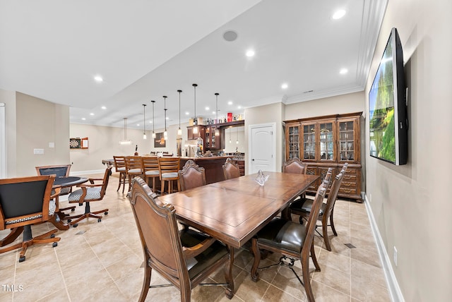 tiled dining area with ornamental molding and bar area