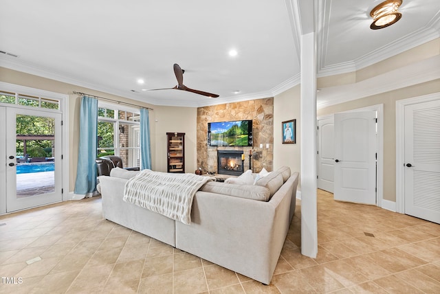 tiled living room with crown molding, a fireplace, ceiling fan, and french doors