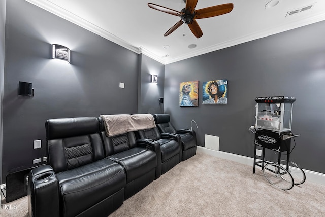 cinema with light colored carpet, ceiling fan, and crown molding