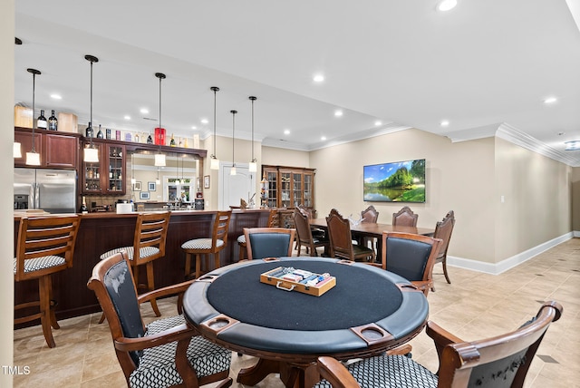 tiled dining room featuring ornamental molding