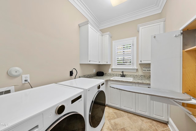 laundry area with cabinets, separate washer and dryer, ornamental molding, and sink