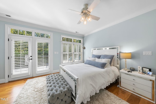 bedroom featuring ceiling fan, access to exterior, wood-type flooring, and crown molding