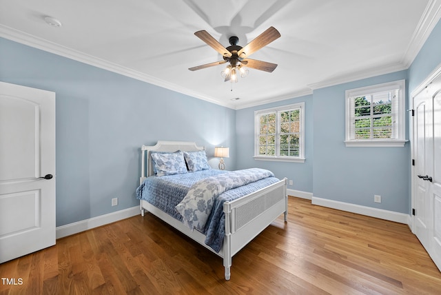 bedroom with hardwood / wood-style flooring, ceiling fan, and crown molding