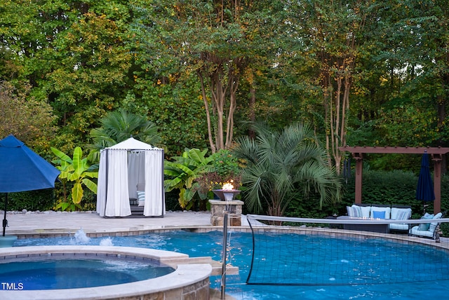 view of pool featuring an in ground hot tub