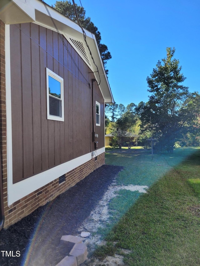 view of side of home with a lawn