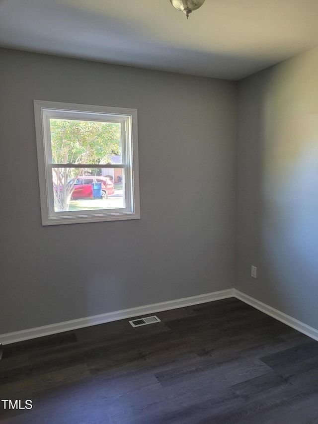 empty room featuring dark wood-type flooring