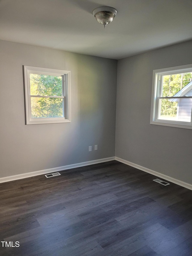 empty room with dark hardwood / wood-style flooring