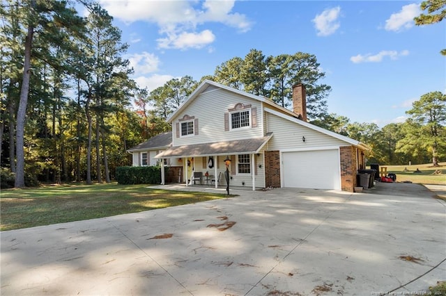 view of front of property with a front lawn, a porch, and a garage