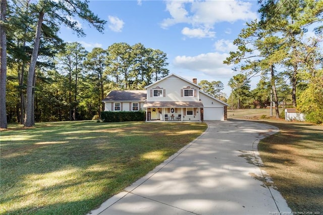 view of front facade featuring a garage, a porch, and a front yard