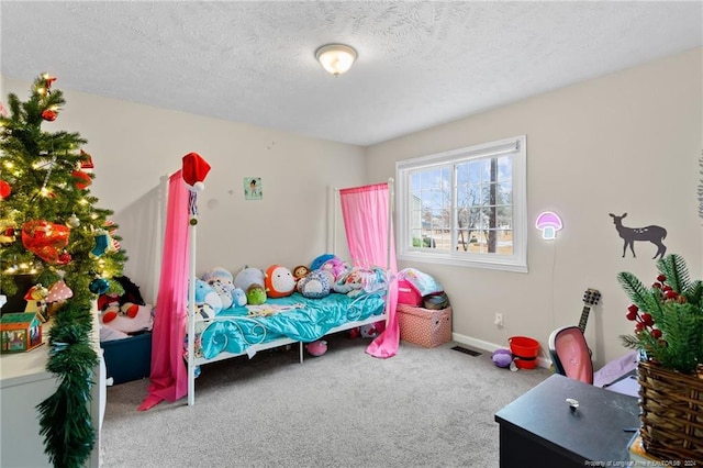 bedroom featuring carpet flooring and a textured ceiling